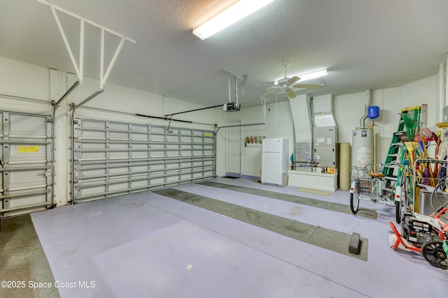 garage featuring gas water heater, a garage door opener, heating unit, ceiling fan, and freestanding refrigerator