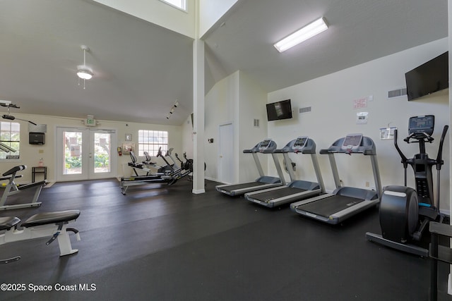 gym with visible vents, high vaulted ceiling, and french doors