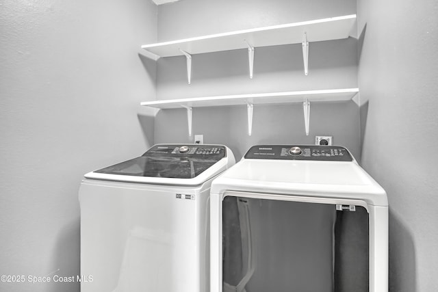 clothes washing area with washer and dryer and laundry area