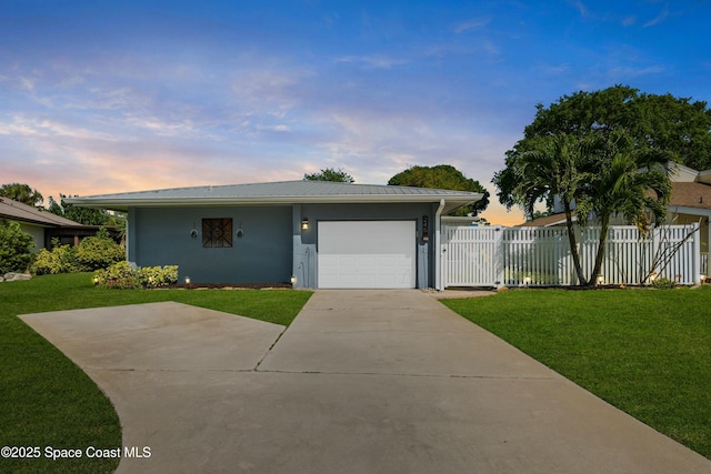 ranch-style home featuring fence, a lawn, driveway, and an attached garage