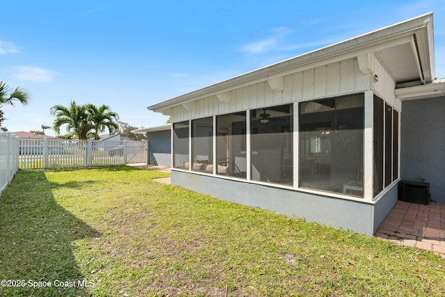 back of house featuring cooling unit, a yard, a sunroom, and a fenced backyard