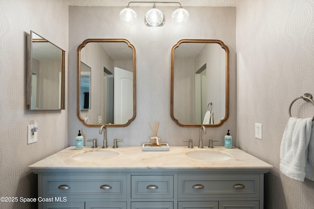 full bathroom with double vanity and a sink