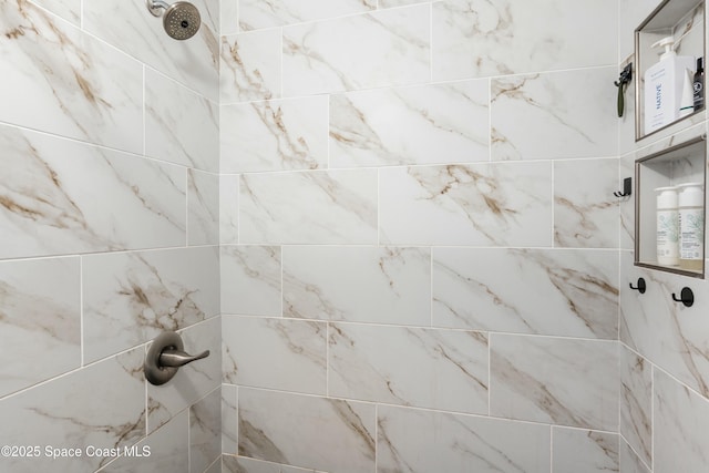 interior details with a tile shower