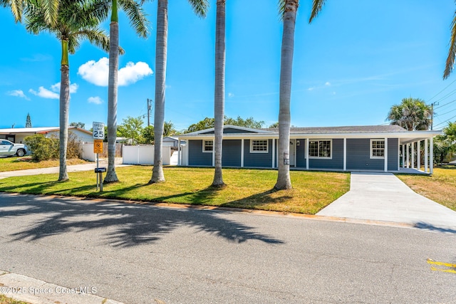 ranch-style house with concrete driveway, a front lawn, and fence