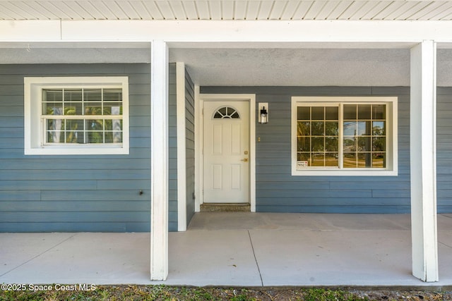 view of exterior entry featuring a porch