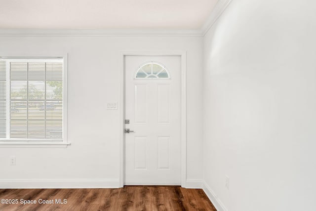 entryway featuring ornamental molding, dark wood-style floors, and baseboards