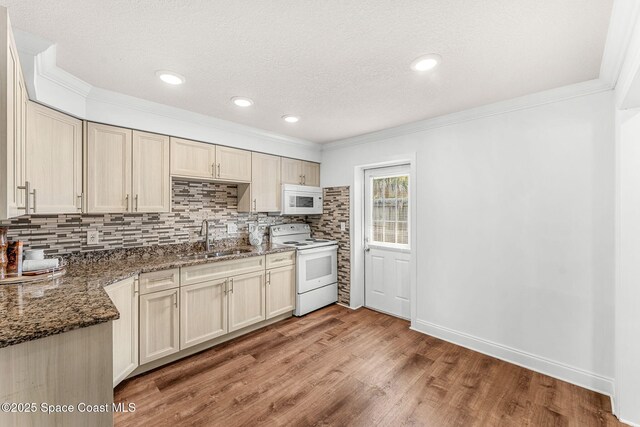 kitchen featuring crown molding, a sink, light wood-style flooring, and white appliances