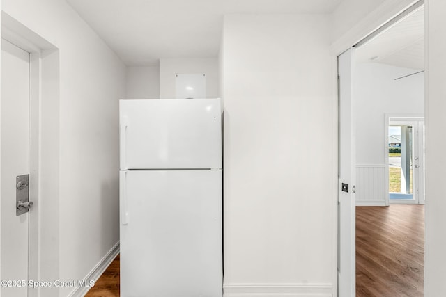 interior space with baseboards and wood finished floors