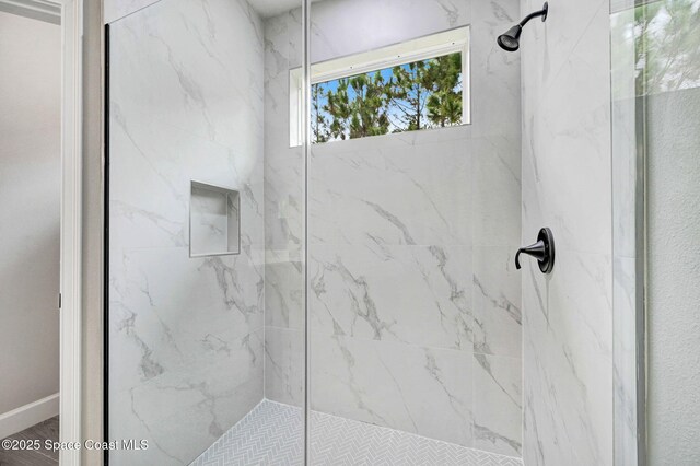 full bath with a marble finish shower
