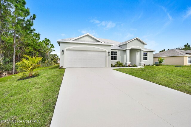 ranch-style home featuring driveway, a front lawn, stucco siding, and an attached garage