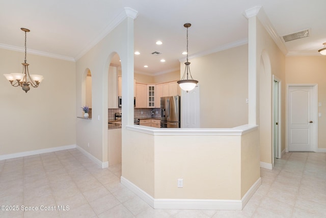 kitchen featuring visible vents, decorative backsplash, glass insert cabinets, stainless steel fridge with ice dispenser, and arched walkways