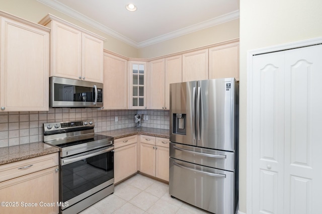 kitchen featuring light brown cabinetry and appliances with stainless steel finishes