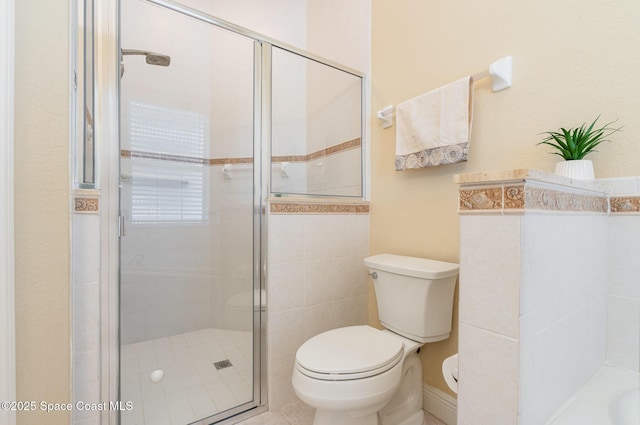 full bathroom with a shower stall and toilet