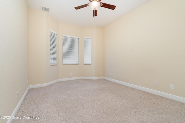 unfurnished room featuring a ceiling fan, baseboards, visible vents, and light carpet