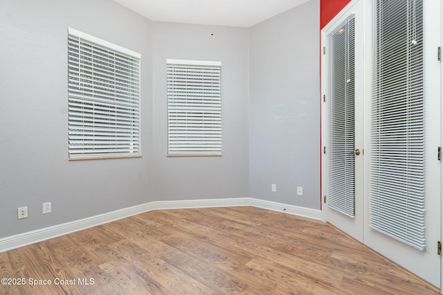 unfurnished bedroom with baseboards and wood finished floors
