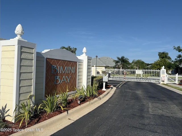 exterior space with a gate, a gated entry, and curbs