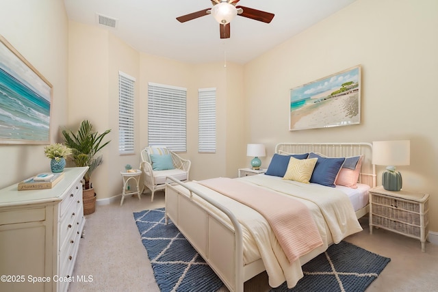 bedroom featuring baseboards, light carpet, a ceiling fan, and visible vents