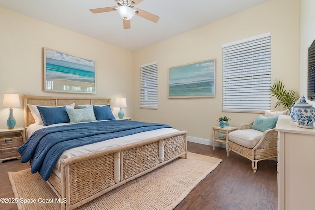 bedroom with a ceiling fan, baseboards, and wood finished floors