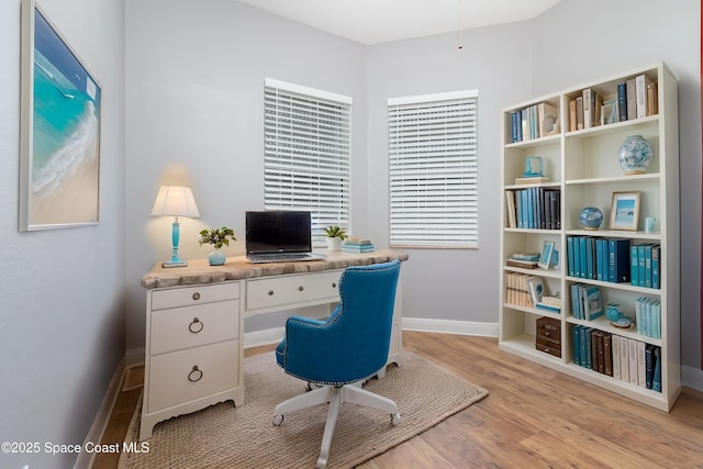 office area with baseboards and wood finished floors