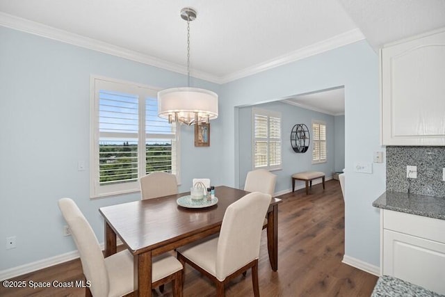 100 Riverside Dr Unit 701, Cocoa, FL 32922 - dining room featuring crown molding, an inviting chandelier, dark wood-style flooring, and baseboards