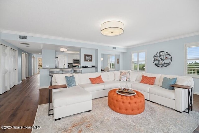 100 Riverside Dr Unit 701, Cocoa, FL 32922 - living room featuring visible vents, wood finished floors, a wealth of natural light, and crown molding
