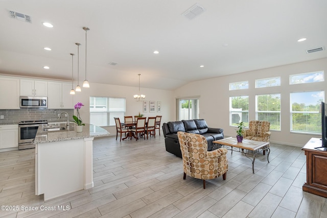 living area with visible vents and wood finish floors