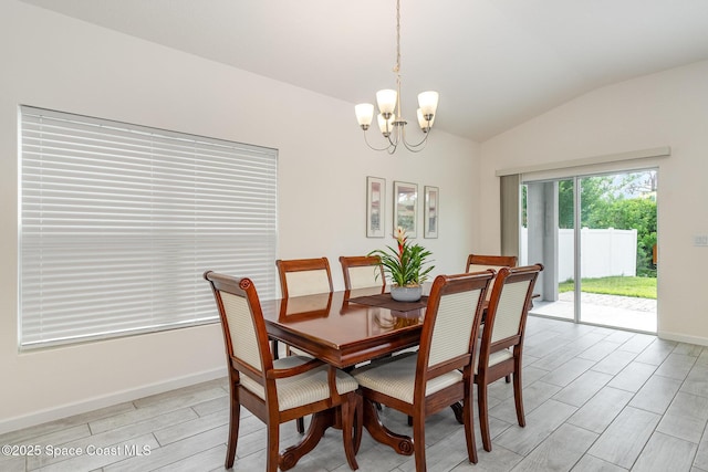 dining area featuring vaulted ceiling, an inviting chandelier, baseboards, and light wood-style floors