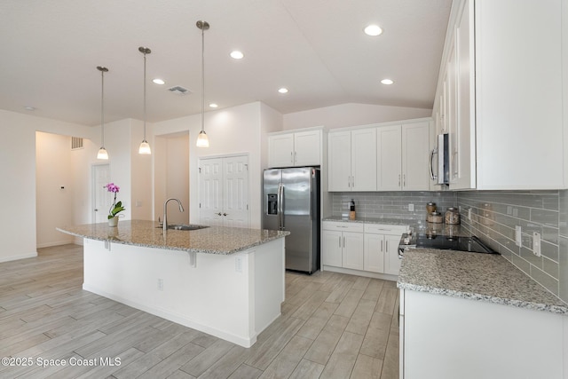 kitchen featuring white cabinetry, light wood finished floors, stainless steel appliances, and a sink