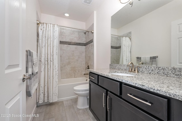 bathroom featuring shower / bath combination with curtain, toilet, wood finished floors, visible vents, and vanity