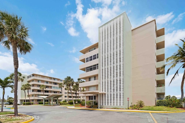 view of building exterior featuring uncovered parking