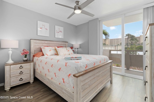 bedroom with a ceiling fan, wood finished floors, and access to exterior