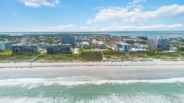birds eye view of property featuring a beach view and a water view