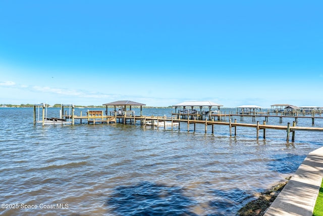 dock featuring boat lift and a water view