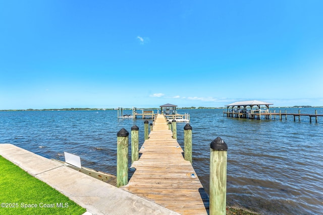 dock area with boat lift and a water view