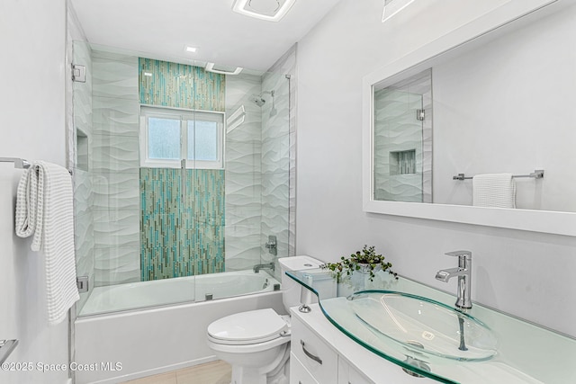 bathroom featuring shower / bath combination with glass door, toilet, and vanity