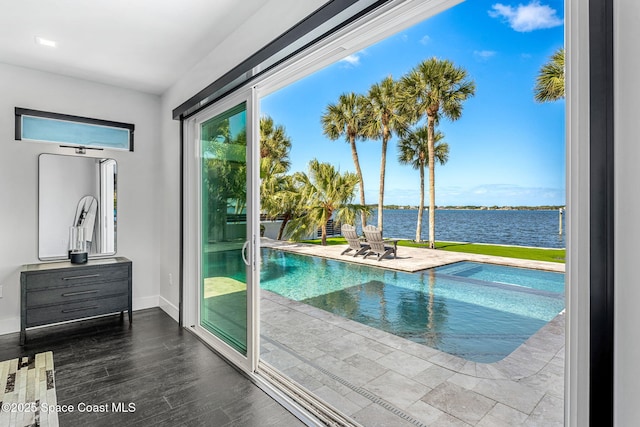 view of swimming pool with a water view