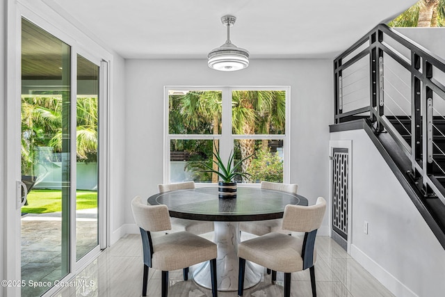 dining space featuring healthy amount of natural light and baseboards