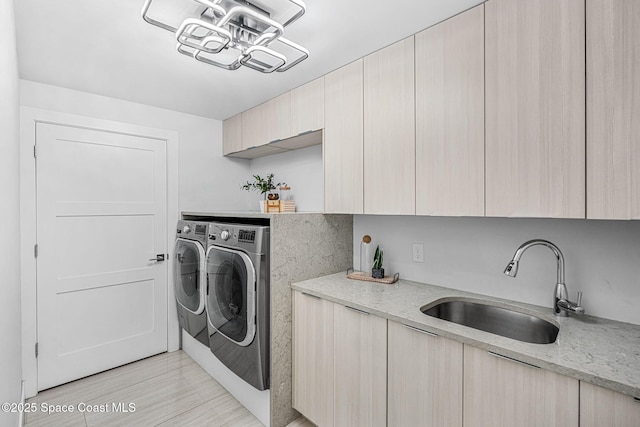 washroom with washer and clothes dryer and cabinet space