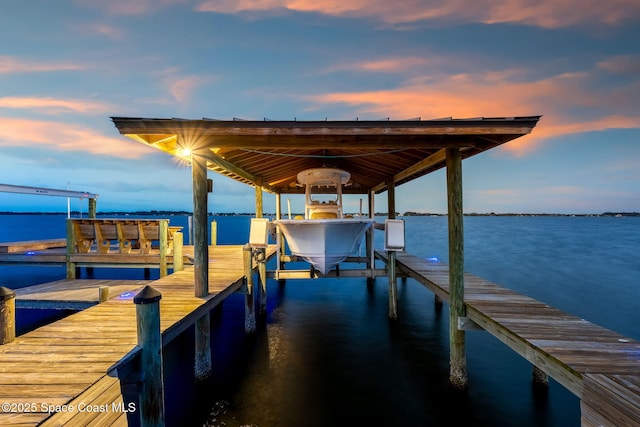 dock featuring boat lift and a water view