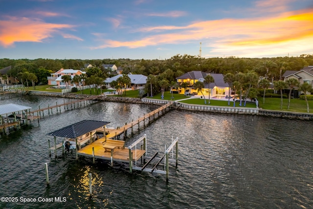 dock area featuring boat lift and a water view