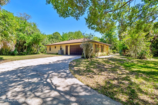 1812 Live Oak Dr N, Rockledge, FL 32955 - ranch-style home with concrete driveway, an attached garage, and cooling unit