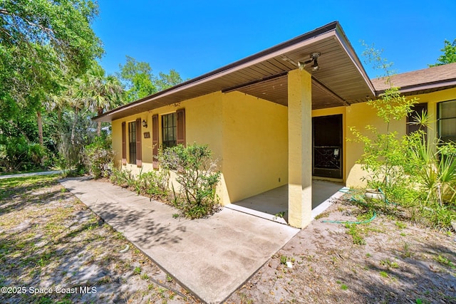 1812 Live Oak Dr N, Rockledge, FL 32955 - view of exterior entry with a patio and stucco siding