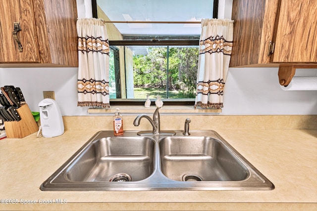 1812 Live Oak Dr N, Rockledge, FL 32955 - kitchen with light countertops, brown cabinets, and a sink