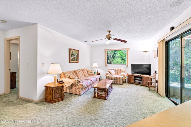 1812 Live Oak Dr N, Rockledge, FL 32955 - living room featuring a textured ceiling, ceiling fan, and light colored carpet