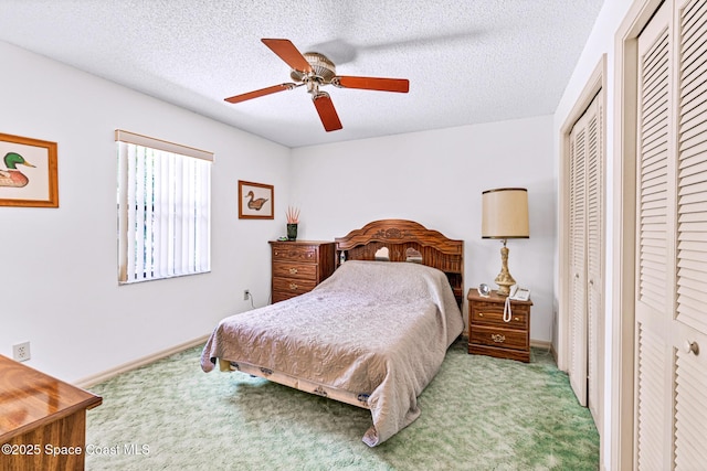 1812 Live Oak Dr N, Rockledge, FL 32955 - carpeted bedroom featuring baseboards, a ceiling fan, a textured ceiling, and two closets