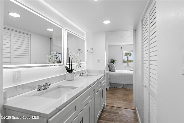 full bathroom featuring recessed lighting, double vanity, ensuite bath, and a sink