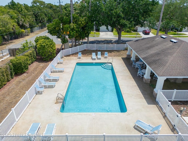 pool featuring fence and a patio area