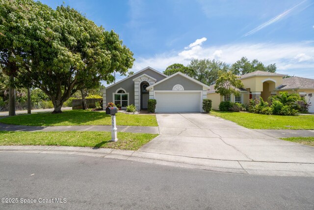 ranch-style house featuring stucco siding, a front lawn, concrete driveway, and a garage