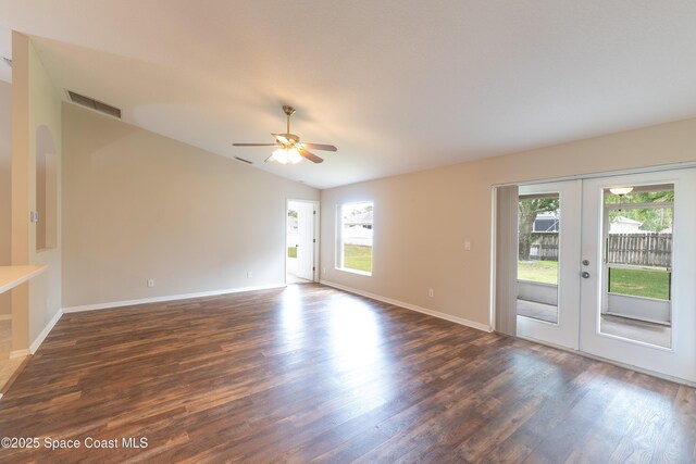 466 Olney St, Palm Bay, FL 32908 - unfurnished living room with dark wood finished floors, a healthy amount of sunlight, french doors, and visible vents