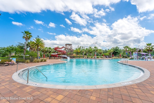 4484 Caladium Cir, West Melbourne, FL 32904 - community pool with a water slide, a patio area, and fence